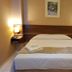 Astro Hotel in São José dos Campos: simple guest room with double bed, bedside lamps, and wall art