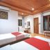 OYO 75353 Loy Chalet Resort room in Nakhon Si Thammarat with twin beds, TV, and large windows