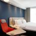 Holiday Inn Express Baden - Baden by IHG room with bed, desk chair and window curtains in Baden-Baden