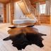 Hotel Leitenhof 4 Sterne Superior in Scheffau am Wilden Kaiser, wood-paneled loft with staircase and cowhide rug