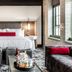 Bottleworks Hotel in Indianapolis guest room with king bed, leather sofa and city-view windows