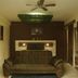 Radio Tulum room with brown sofa bed, ceiling fan, and leafy wall feature in Tulum