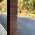 Kingswood Motel in Tocumwal exterior walkway with brick columns and white chairs beside the driveway