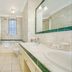 44 Curzon Street by Mansley in London bathroom with marble walls, double sink vanity and bathtub