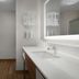 Hampton Inn Yorkville bathroom with walk-in shower and white vanity