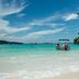Phi Phi Cliff Beach Resort in Ko Phi Phi with a tropical beach and boat in clear turquoise water