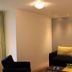 Strandhotel Achtert Diek in Langeoog lounge with black sofa, floor lamp and seating area