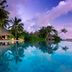 Milaidhoo Maldives in Kamadhoo with a tropical infinity pool, palm trees, and overwater lagoon views