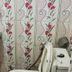 Om Mandakini Hotel Kathmandu bathroom with wall-mounted sink, tiled floral wall, and toilet