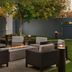 Courtyard by Marriott Dallas Lewisville outdoor patio with fire pit, wicker seating and trees in Lewisville