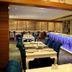 Rota Bulvar Hotel Ankara restaurant interior with set tables and a glowing blue-lit bar