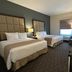 Best Western Plus Chihuahua Juventud guest room with two beds, desk, and window seating in Chihuahua