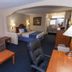 Downtowner Inn and Suites in Houston guest room with two beds, sofa, desk, and seating area