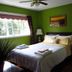 The Grateful Bed B'n'B in Prince George bedroom with green walls, queen bed, window, and bedside lamps