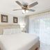 Westgate Historic Williamsburg Resort bedroom with king bed, ceiling fan, bedside lamps and large window