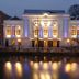 Golden Tulip Leiden Centre in Leiden, illuminated waterfront hotel facade reflected on the canal