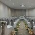 Delta Hotels by Marriott Waltham Abbey wedding ceremony room with aisle lanterns and draped chairs