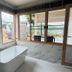Mon Ing Dao in Mae Rim bathroom with freestanding tub beside large windows and mountain view