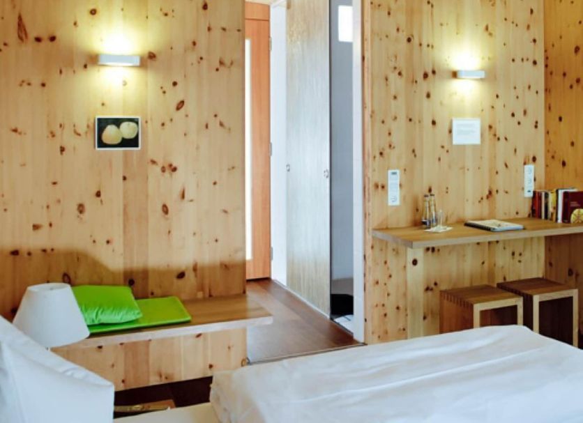 Hörger Biohotel und Tafernwirtschaft in Kranzberg, wood-paneled guest room with twin beds and a small desk