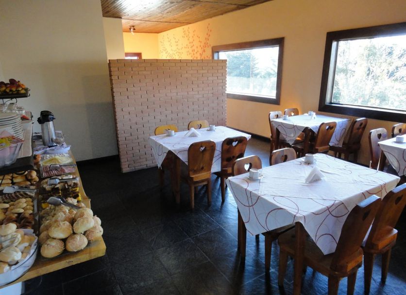 Pousada Atalaia in Campos do Jordão dining room with breakfast tables and buffet spread