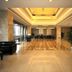 Xiang Ming Holiday Hotel in Huangshan lobby with polished floors, seating area and chandelier lighting