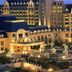 Hilton Qingdao Golden Beach in Qingdao with illuminated tower and landscaped courtyard at dusk