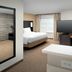 Residence Inn by Marriott Lubbock Southwest guest room with bed, desk, TV and large windows in Lubbock