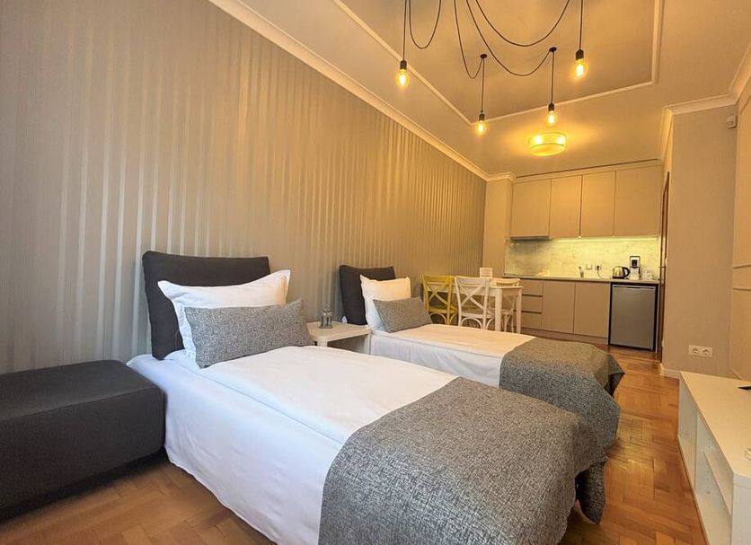Dunav Apartment House Sofia twin bedroom with kitchenette and warm hanging lights