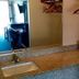 Coral Roc Motel Florida City bathroom vanity with sink, mirror, and hanging clothes rods