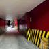 Astrotel Cubao in Quezon City, a narrow painted tunnel corridor with black and yellow striped walls