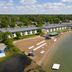 Tawas Bay Beach Resort in East Tawas with a sandy beach, lakeside dock, and waterfront rooms