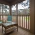 Pawleys Plantation Golf & Country Club screened porch in Pawleys Island with chairs and a wicker table