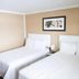 Bryce Uptop Lodge in Bryce guest room with two white beds and framed wall art