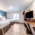 Woodspring Suites Indianapolis Castleton room with two beds, TV desk and window in Indianapolis