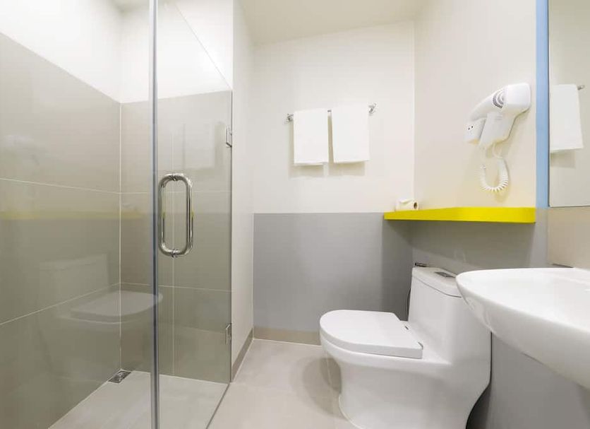 Hop Inn Hotel North Edsa Quezon City bathroom with glass shower, toilet, and sink in Manila