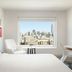 Luma Hotel San Francisco room with large window and city skyline view in San Francisco