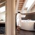 Al Tezzon Hotel in Camposampiero: suite view with walk-in closet, bedroom, and woman in a bathtub bathroom