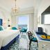 Grand Hotel Ambasciatori, Sorrento room with sea view balcony, blue accents, and twin chairs