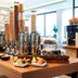 Breakfast buffet at Nyx Hotel Mannheim by Leonardo Hotels in Mannheim with cereal dispensers and fruit bowls