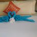 Karibu Aruba in Noord with swan towel art and flower accents on a neatly made bed