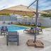 Casa Toñita in Levittown with an outdoor pool, lounge chairs, umbrellas, and a rooftop-style terrace