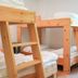 Arena Surf Hotel in Somo: bright room with wooden bunk beds and a window view
