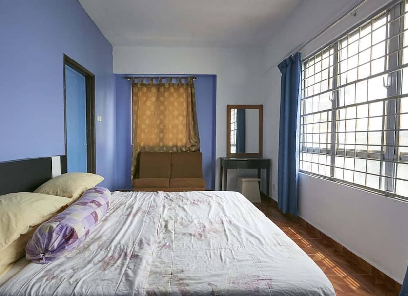 JC Sunshine Bay Resort Port Dickson room with bed, window seating nook and large window