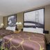 Super 8 by Wyndham Houghton Lake guest room with two beds, framed wall art, and a window view