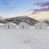 Tromsø Lodge & Camping in Tromsø, snowy cabin-style lodges with mountain views at dusk