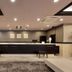 Minamisenri Crystal Hotel lobby reception desk in Suita with seating and recessed ceiling lights