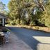 Kingswood Motel in Tocumwal with outdoor patio seating beside a tree-lined drive