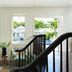 Winslow's Bungalows in Key West lounge with curved staircase and tropical pool view through windows