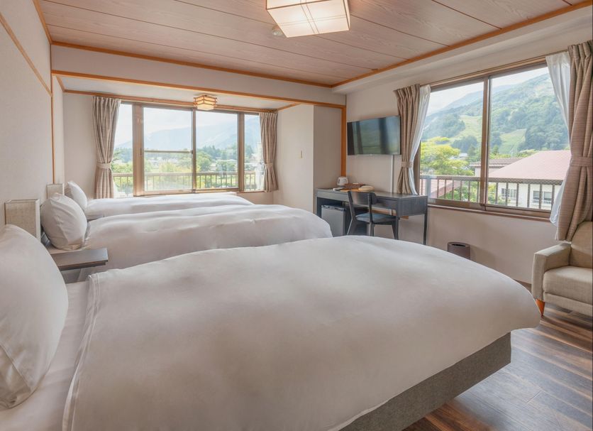 Summit Views Hakuba, Hakuba hotel room with twin beds and mountain views through large windows