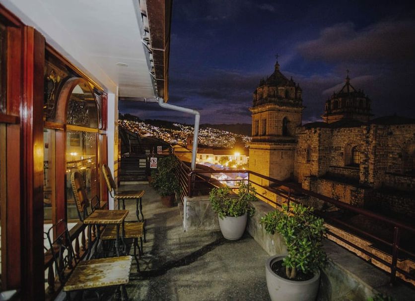 Quechua Hotel Cusco in Cusco balcony with city lights and historic church views at night